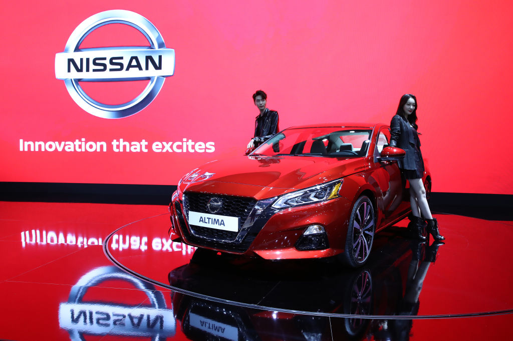 Models pose next to a NISSAN Altima at the Seoul Motor Show 2019 at KINTEX on March 28, 2019 