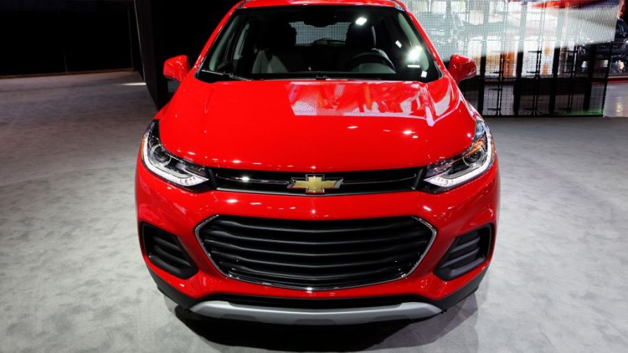 A red Chevy Trax on display at an auto show
