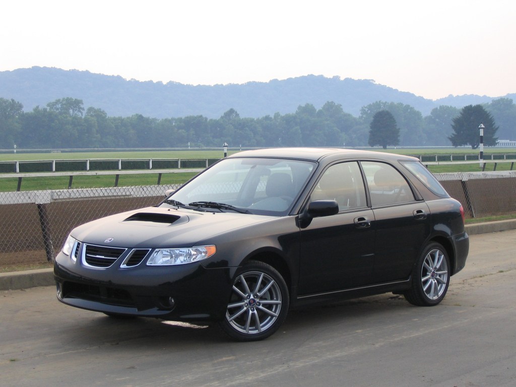 A black 2005 Saab 9-2X parked off of a scenic highway.