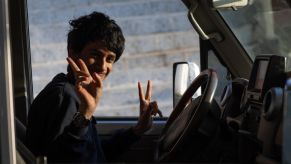 Teenage boy driving a car