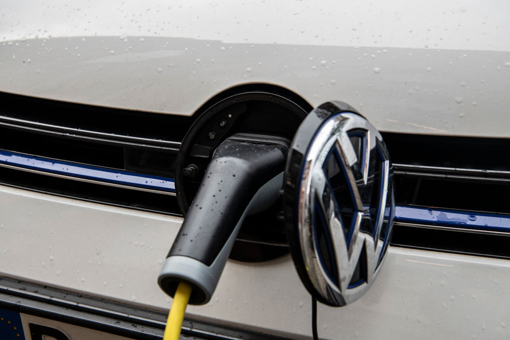 An electric Volkswagen car at a charging port