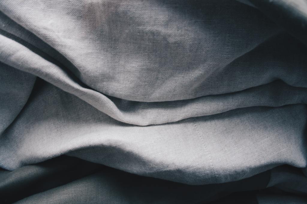 A close-up of a grey blanket for use in roadside emergency kits.