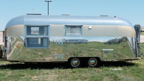vintage Airstream RV and Camper model trailer parked on the grass at an event