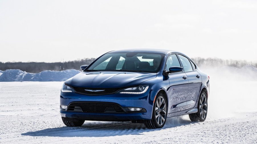 A blue 2015 Chrysler 200 AWD kicks up snow.