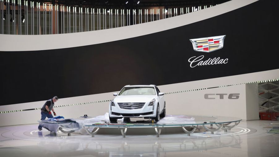 A worker prepares a Cadillac CT6 display for the opening of the Chicago Auto Show