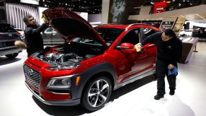 Workers clean a Hyundai Kona at the Hyundai exhibit at the 2018 North American International Auto Show