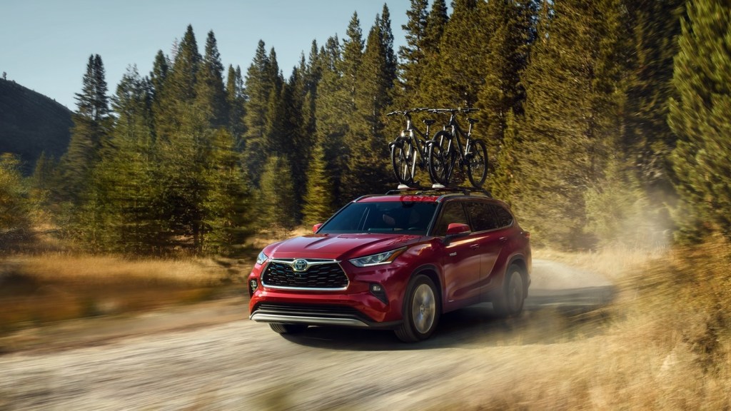 2020 Toyota Highlander Hybrid driving down dirt road 