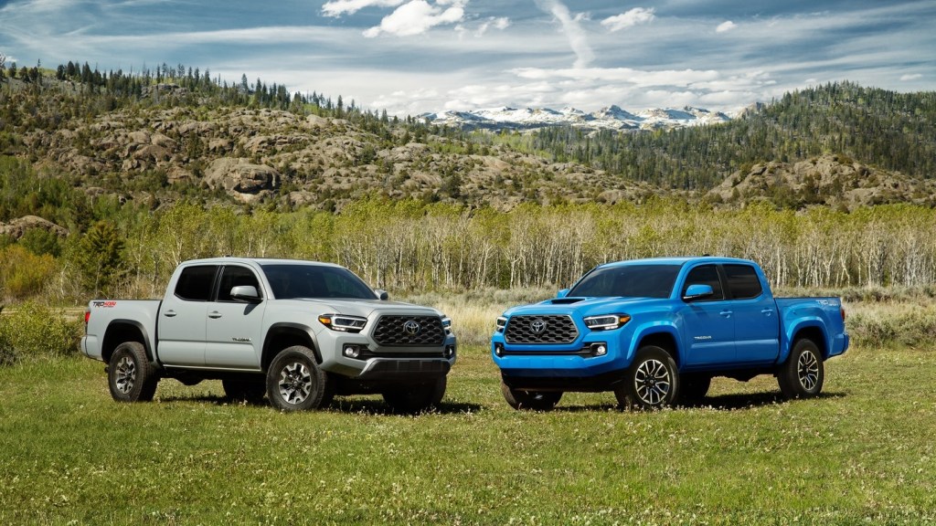 Two 2020 Toyota Tacoma TRD Off-Road trucks parked in a field 