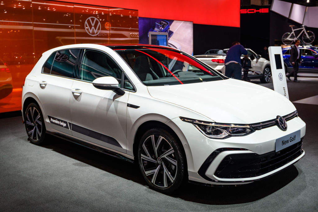 A white Volkswagen Golf on display at an auto show