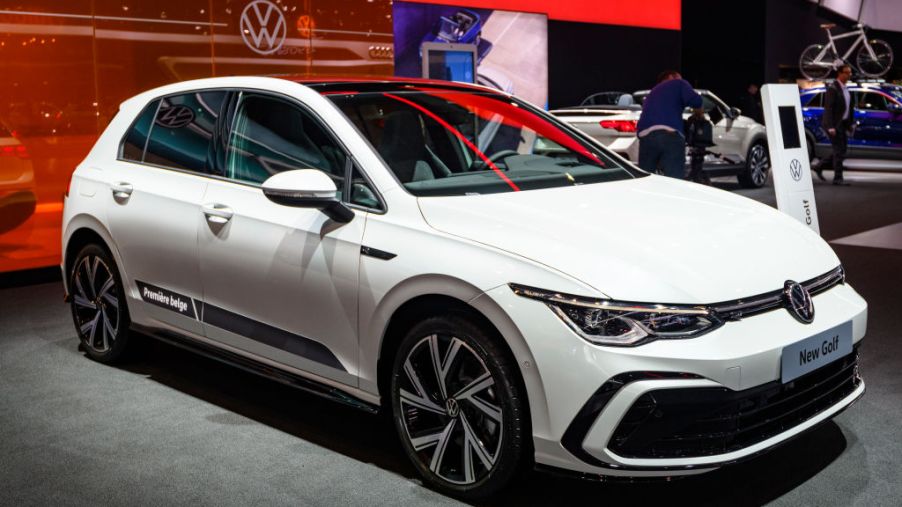 A white Volkswagen Golf on display at an auto show