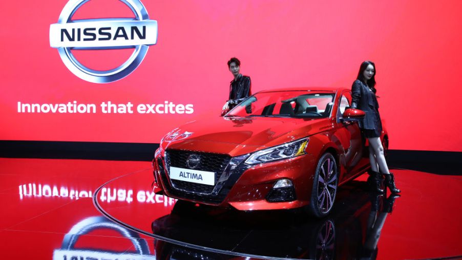 Models pose next to a NISSAN Altima at the Seoul Motor Show 2019 at KINTEX on March 28, 2019