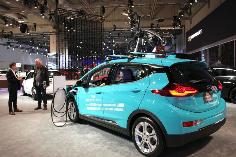 People look at a Chevrolet Bolt EV car during 2020 Canadian International Autoshow