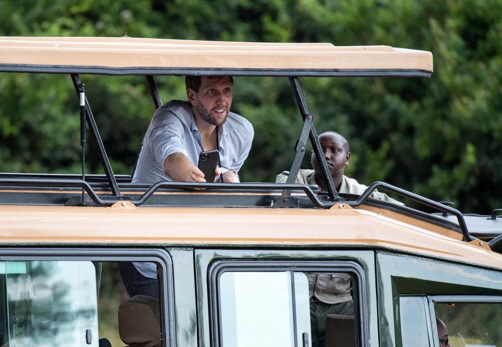 Dirk Nowitzki (l), a former basketball player, looks out from a jeep roof during a tour of Nairobi National Park by the delegation of the Federal President Steinmeier