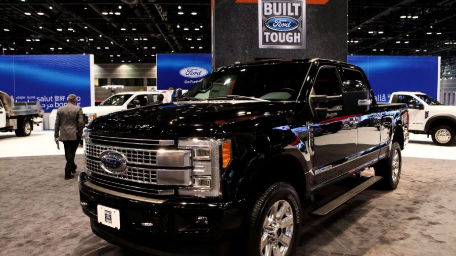 A black Ford F-250 on display at an auto show