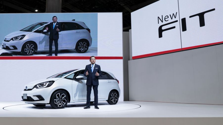 Honda Motor Co. President Takahiro Hachigo speaks in front of the company's redesigned Fit compact vehicle during a press conference at the Tokyo Motor Show