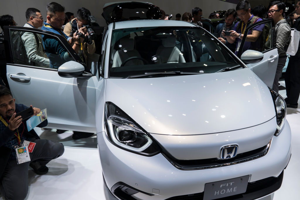 Members of the media look at Honda Motor Co.'s redesigned Fit compact vehicle during a press conference at the Tokyo Motor Show