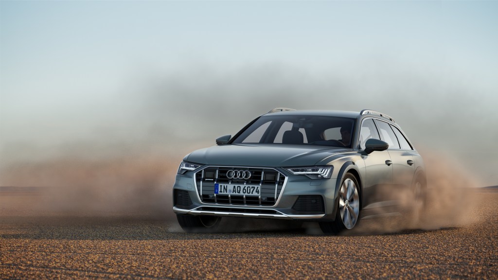 A silver Audi A6 station wagon plays in the desert.