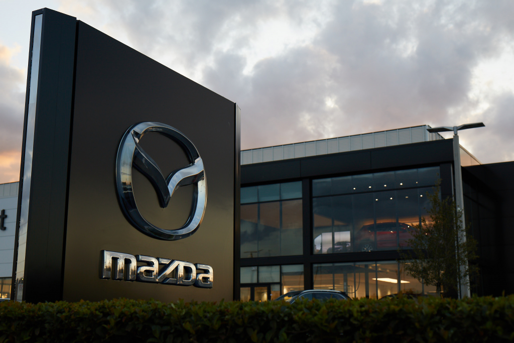 Mazda logo in front of a modern office building 