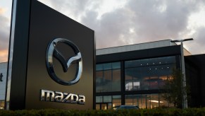 Mazda logo in front of a modern office building