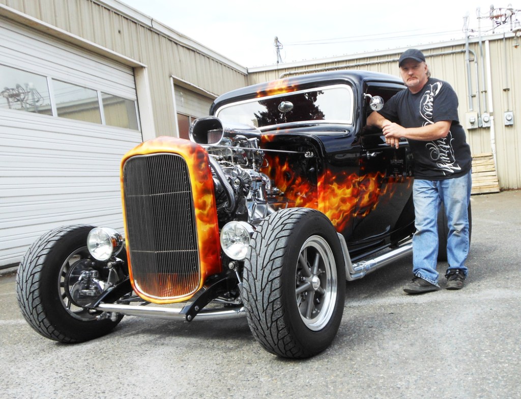 Custom paint and airbrush master Mike Lavallee stands by a sample of real-like flames created using his True Fire technique and templates