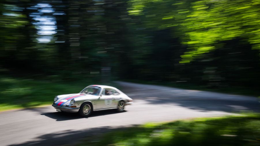 Severine Loeb and her copilot Denissa Fonjallaz are seen driving their Porsche 911 S on the road