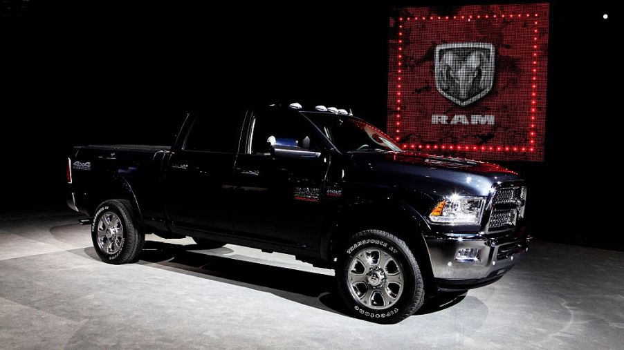 A black heavy duty Ram pickup truck on display at an auto show