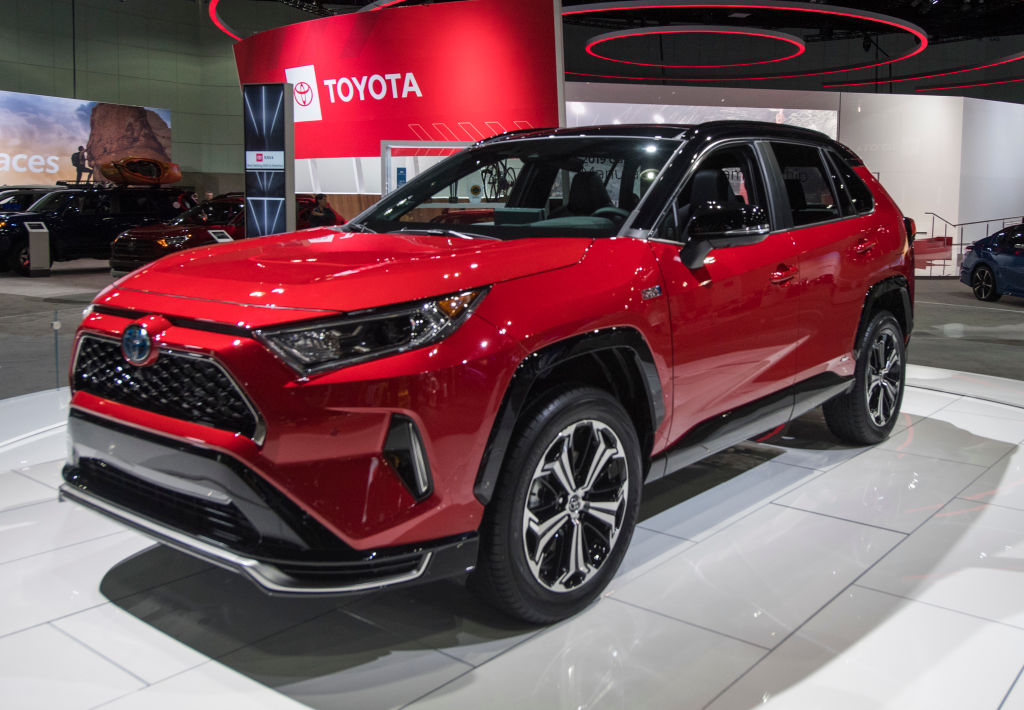A red Toyota RAV4 on display at an auto show