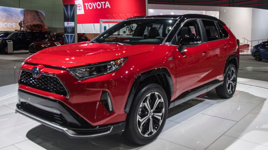 A red Toyota RAV4 on display at an auto show