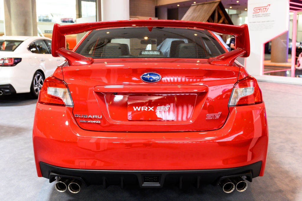 A red Subaru WRX STI on display at an auto show