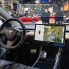 Tesla Model 3 compact full electric car interior with a large touch screen on the dashboard on display at Brussels Expo