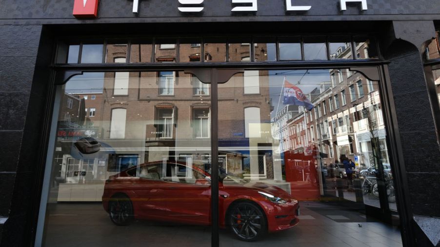 A logo of Tesla is seen outside its showroom
