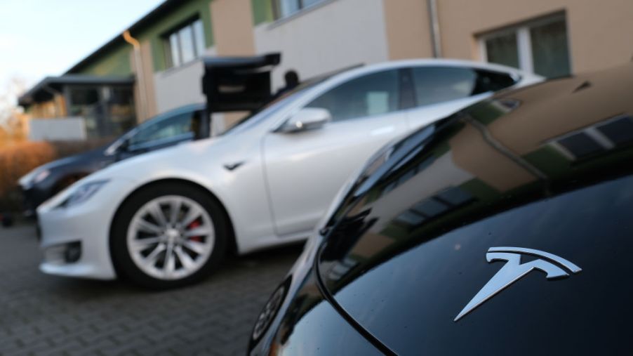 Electric cars of US automaker Tesla stand outside the Hangelsberg community center