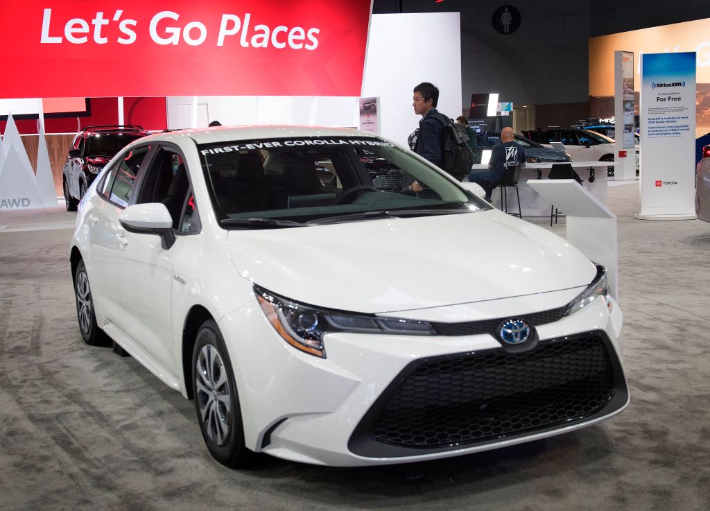 A 2020 Toyota Corolla Hybrid on display at an auto show