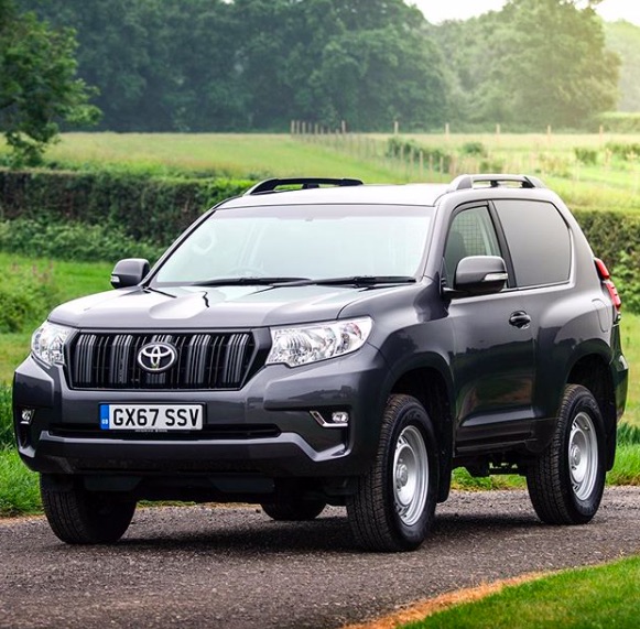 a 2-door Toyota Prado driving in the country