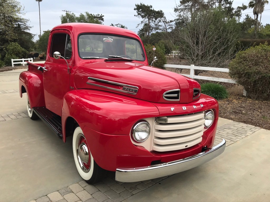Red 1950 Ford F-1 pickup truck with cream grille