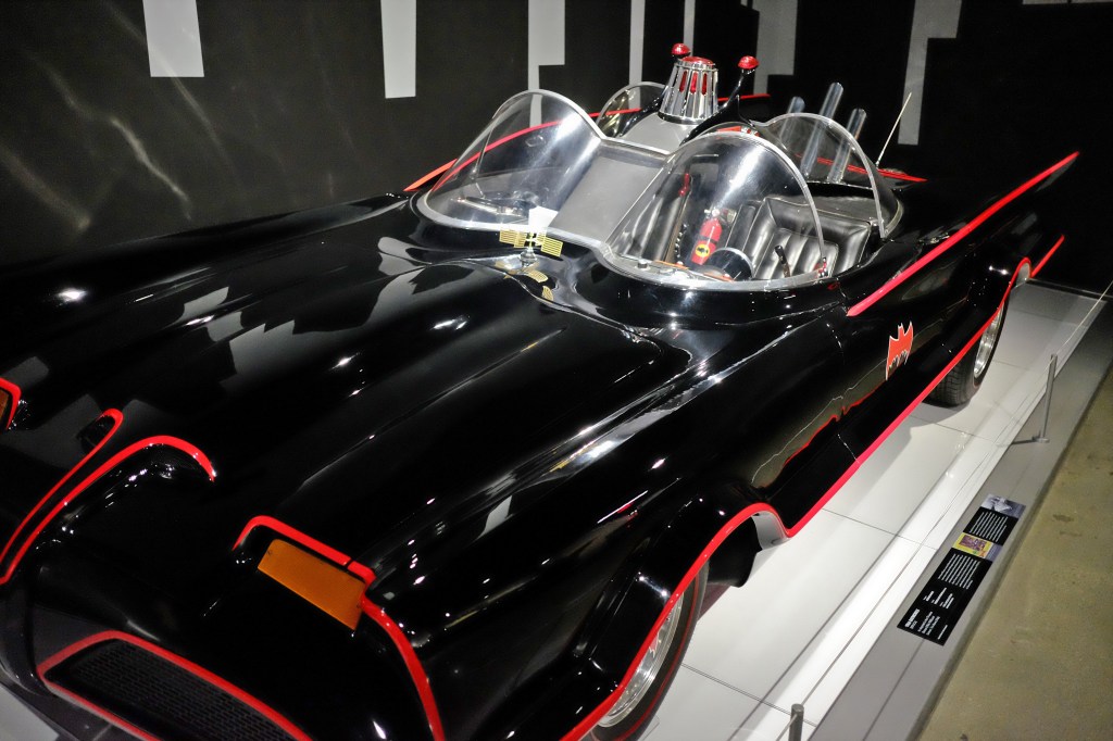 A replica of the Batmobile from the television series sits on display