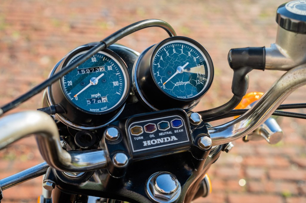 1973 Honda CB350 Four handlebar and gauges showing 10,000 RPM redline, speedometer, and indicator lights