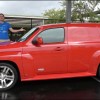 Red 2009 Chevrolet HHR SS wagon panel van version, side view, with Doug Demuro behind it