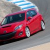 Red 2010 Mazdaspeed3 going around a corner