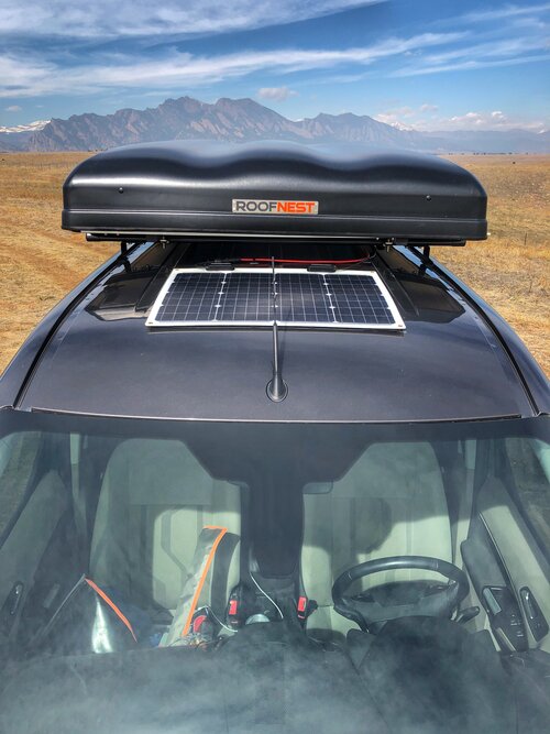 Conversion by Contravans that includes a solar panel and rooftop tent.