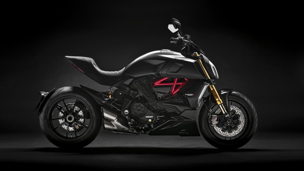 Black 2019 Ducati Diavel 1260, side view, against a black background