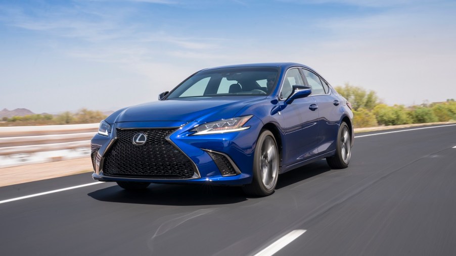 A blue 2020 Lexus ES shows off its luxury car styling on a desert road.