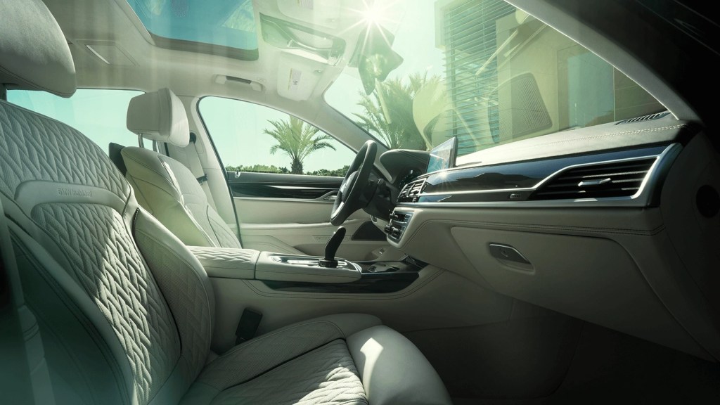 2020 Alpina B7 interior, showing white quilted leather seats and dark wood trim