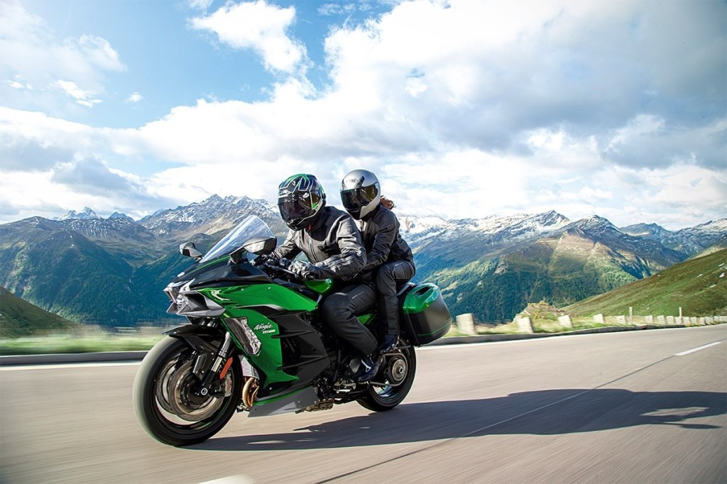 Green 2020 Kawasaki Ninja H2 SX SE+, with 2 riders on a mountain road
