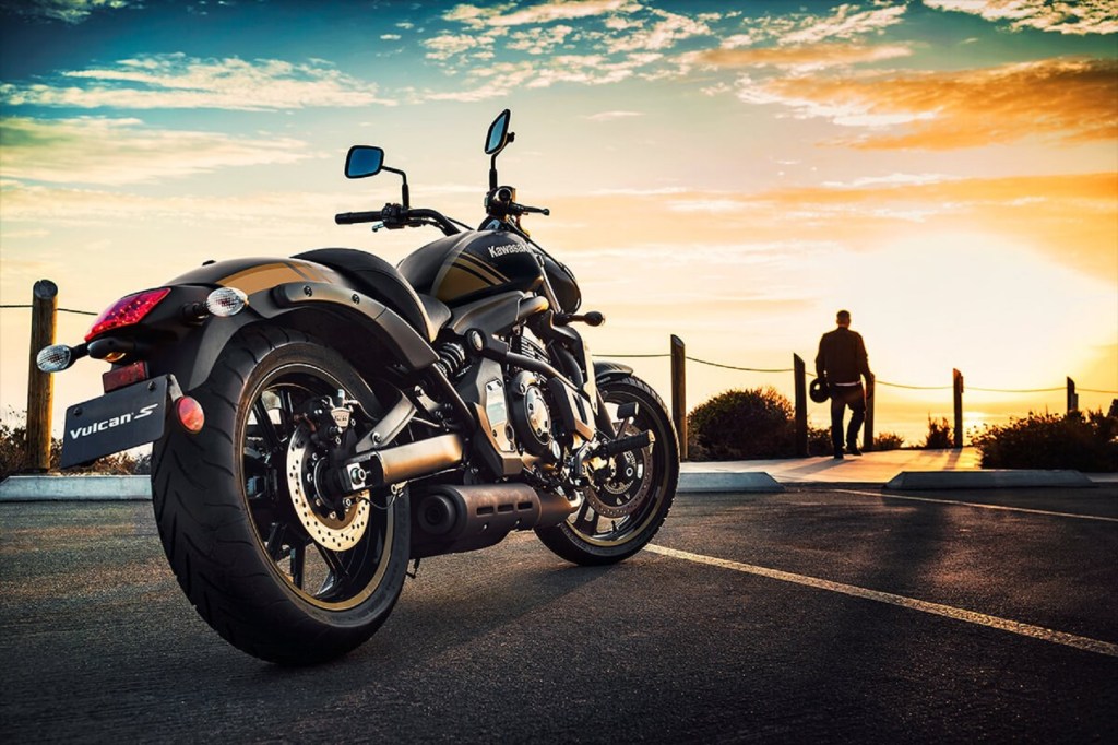 Side-rear view of a black-and-gold 2020 Kawasaki Vulcan S, parked in front of the setting sun