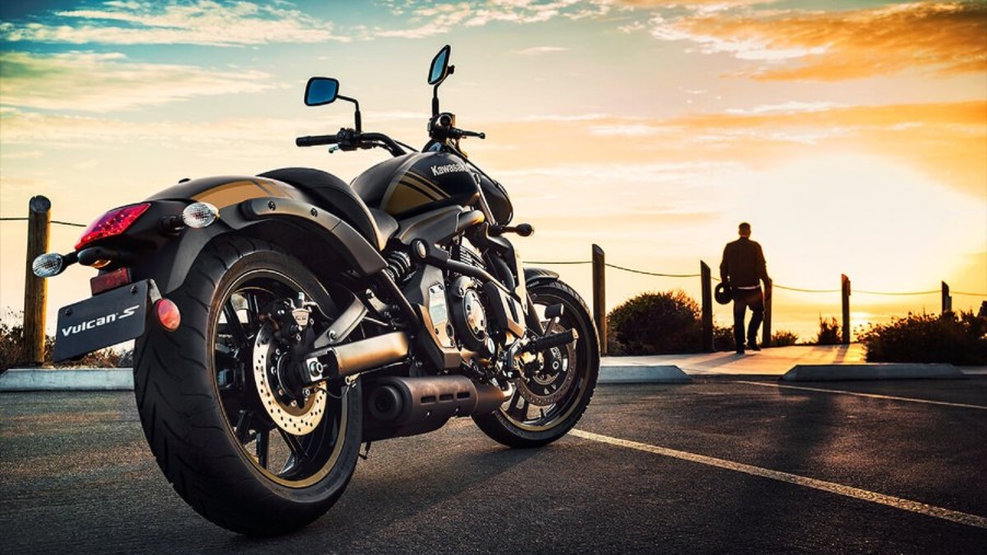 Side-rear view of a black-and-gold 2020 Kawasaki Vulcan S, parked in front of the setting sun