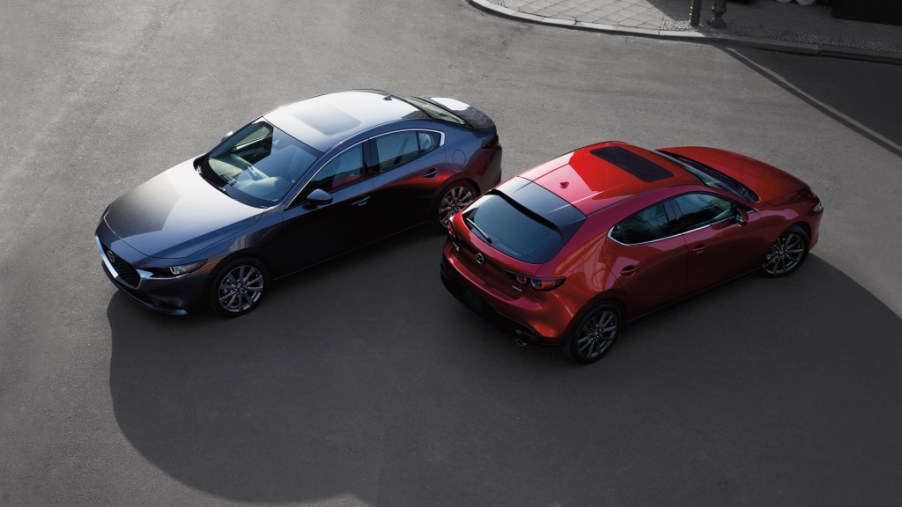 a gray sedan and a red hatchback from a sky view