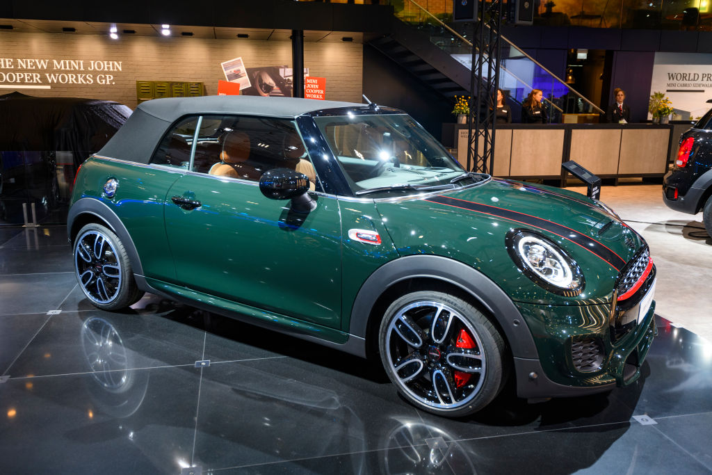 A Mini Cooper convertible on display at an auto show