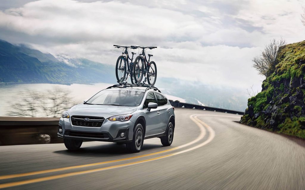 2020 Subaru Crosstrek Premium driving with bikes on the roof rack
