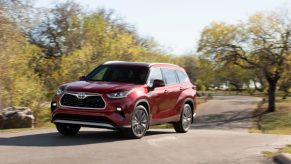 2020 Toyota Highlander Hybrid driving on road in the sun